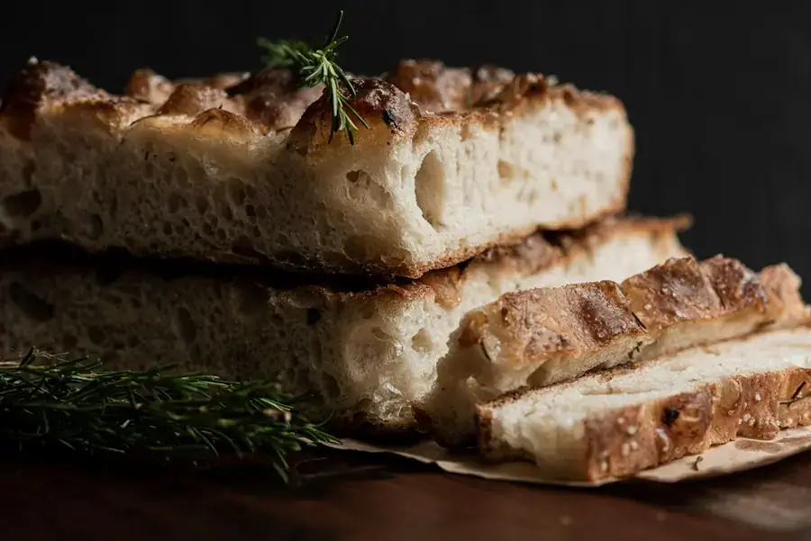 Slices of rosemary focaccia showing an airy crumb